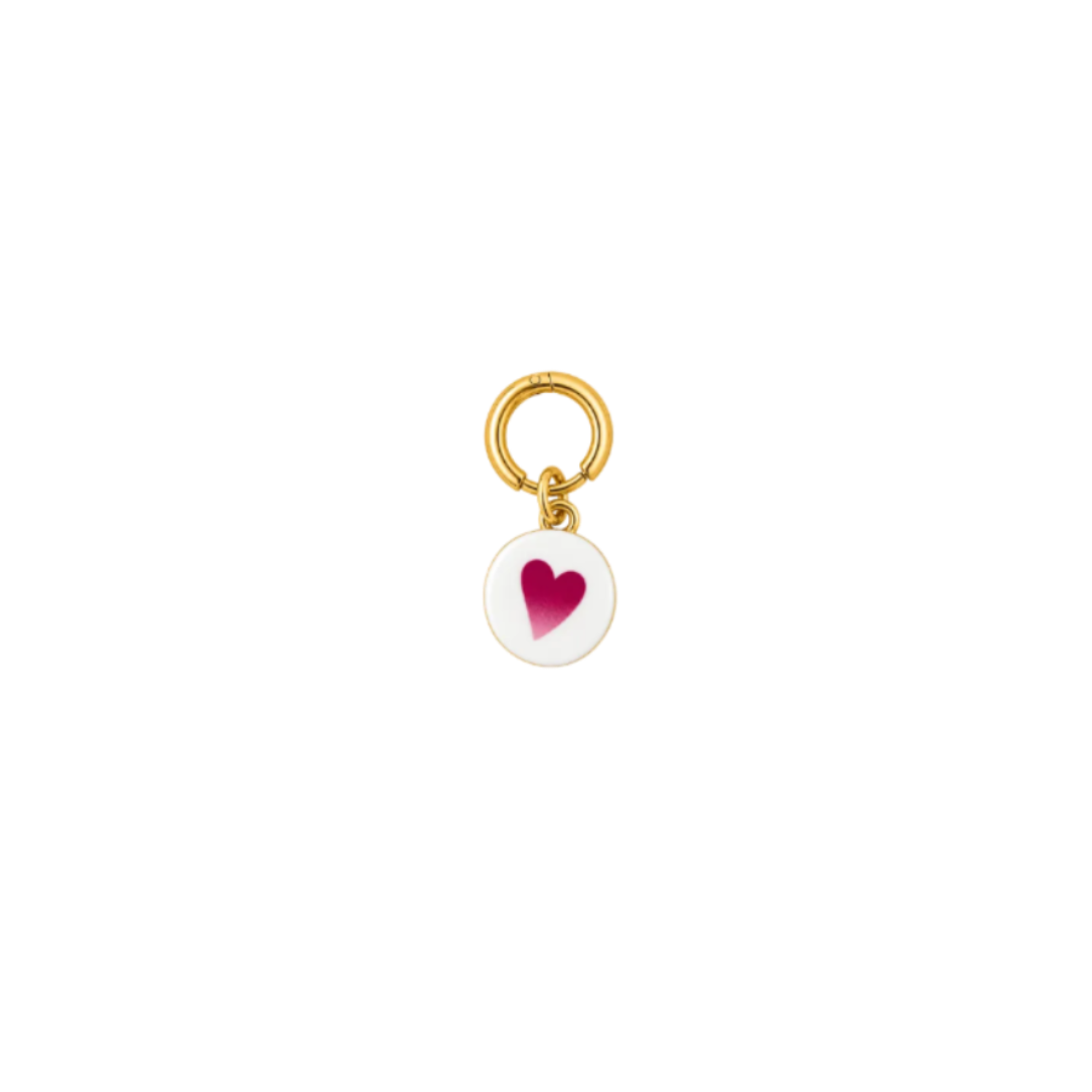 A small gold charm featuring a circular white disc with a pink heart in the center, suspended from a gold ring on a plain white background.