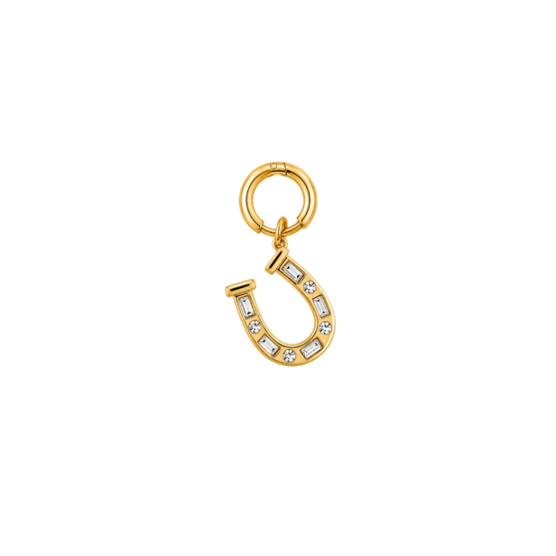 A gold horseshoe charm embellished with small clear crystals, attached to a matching gold split ring, shown on a plain white background.